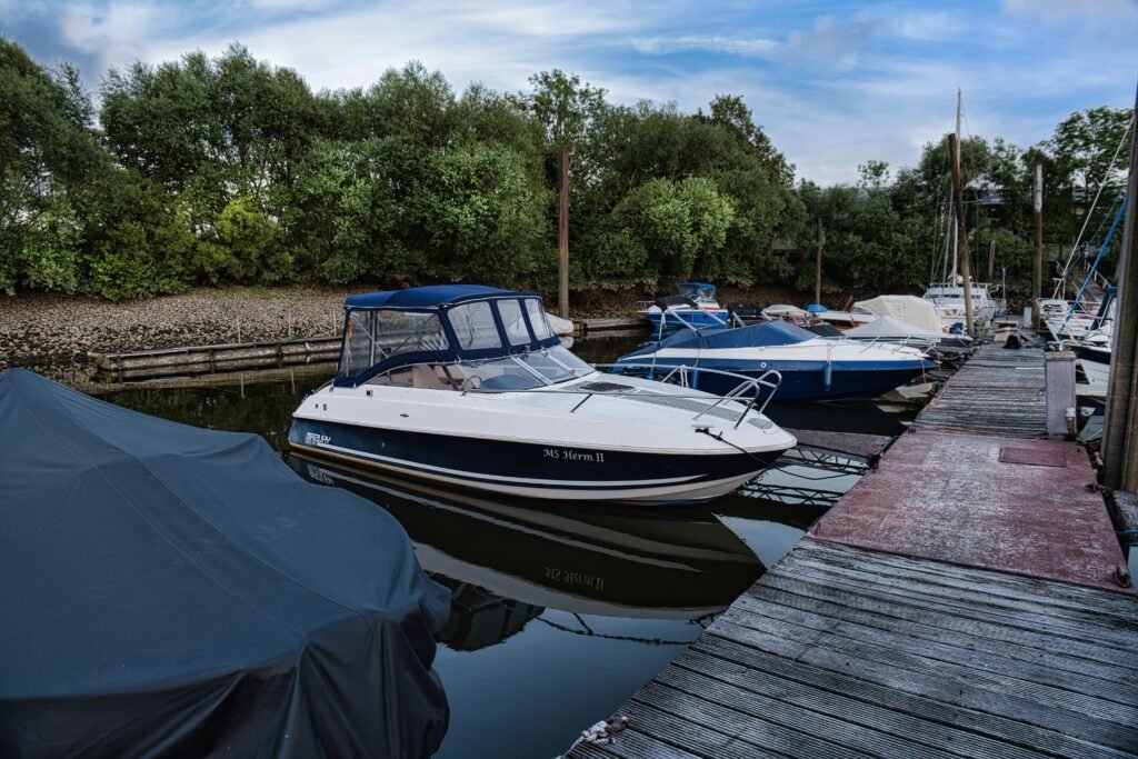 Tranquil marina scene with docked motorboats and lush greenery, perfect for travel explorations.